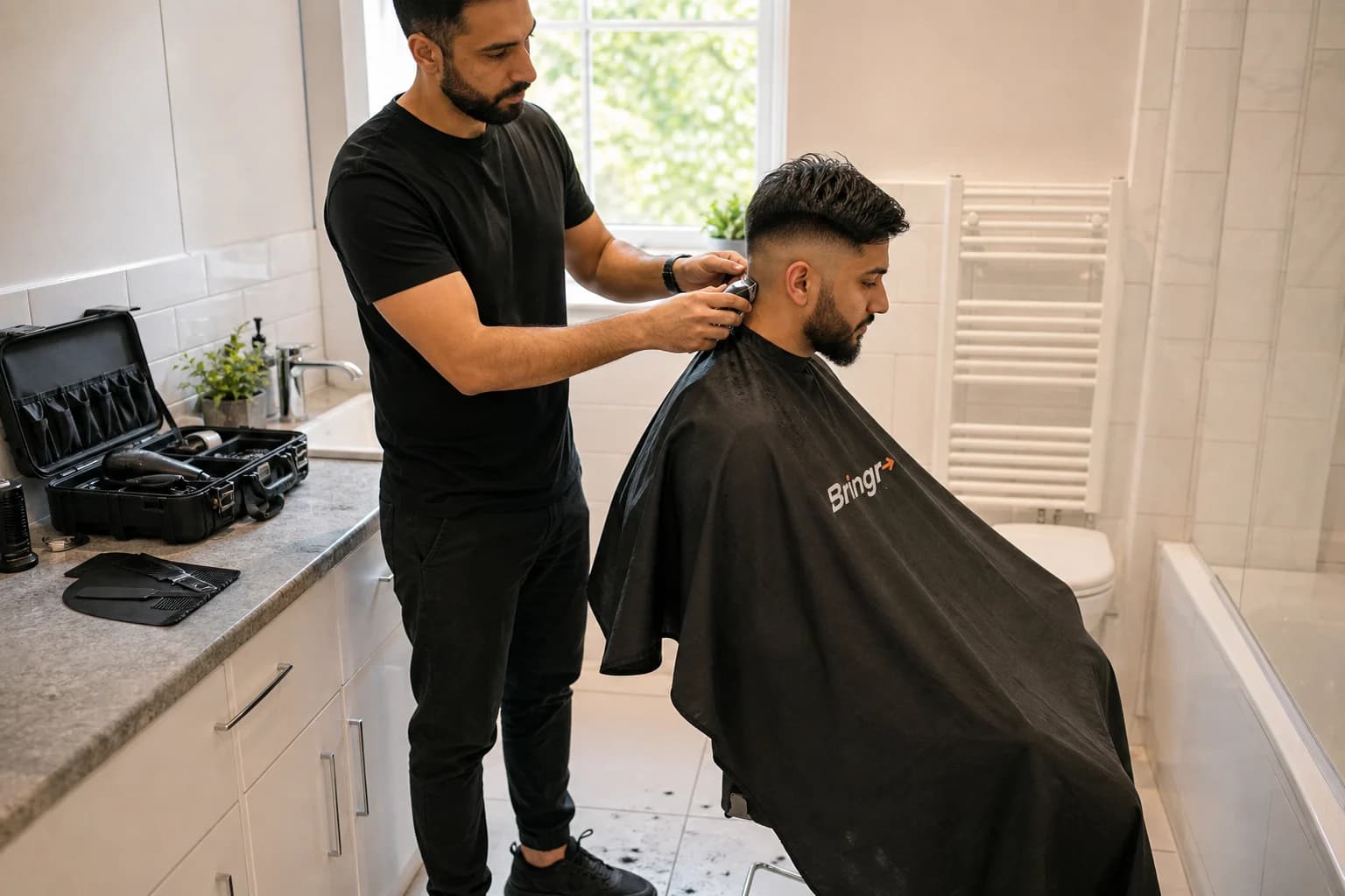 An independent barber giving a customer a haircut in a bright bathroom with tiled flooring